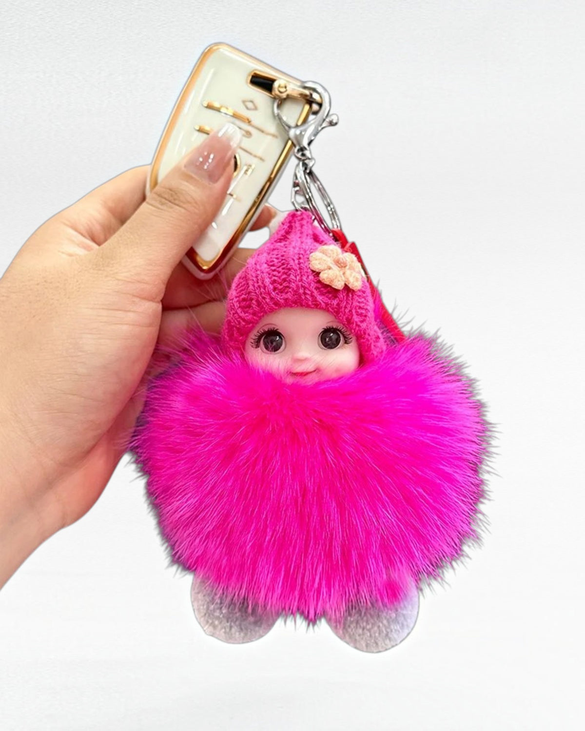 Pink fluffy doll keychain with faux fur pom-pom, knitted hat and metal clasp by Zuphar