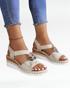 Women's beige platform wedge sandals with open toe and metallic decorative buckle