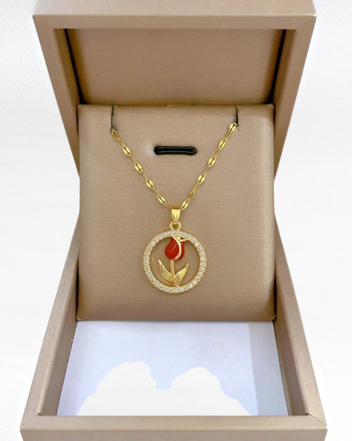 Red rose pendant necklace with gold-tone stainless steel chain and sparkling circular floral pendant